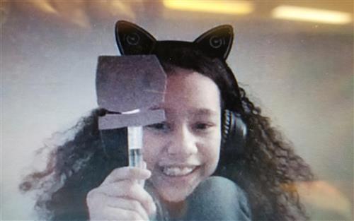 Student in onine Future Makers Club dispalys her final project called Super Monster Mouth showing students the science of kinetic energy.